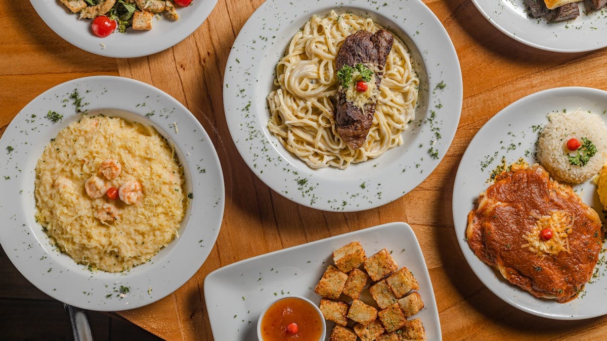 A top view of various gourmet dishes beautifully plated, showcasing Brazilian cuisine.